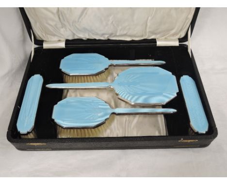 A cased silver dressing table brush and mirror set having Art Deco style pale blue guilloche enamel decoration, Birmingham 19