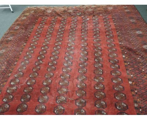 An early/mid 20th century carpet square of turkmen design having red ground, 172'x105'