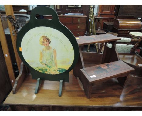 A modern stained frame seat steps having painted decoration and a modern firescreen with advertising panel