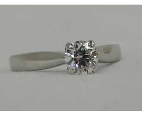 A lady's diamond solitaire dress ring, approx .75ct in a four point claw mount on a platinum loop, size M, retailed by Hearts