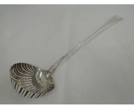 A Georgian silver soup ladle having shell formed bowl and feather edging to handle with plain terminal, London 1767, makers m