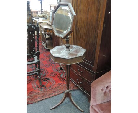 An Edwardian mahogany shaving stand having chevron inlay decoration with octagonal adjustable mirror over similar lift lid ti