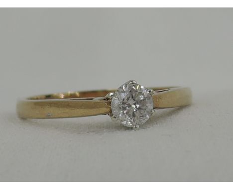 A lady's diamond solitaire dress ring, approx .4ct in a claw mount to raised shoulders on a 9ct gold loop,  size R