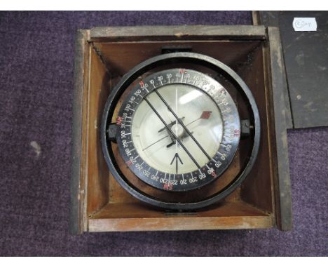 A military gimble compass in wooden box, in working order