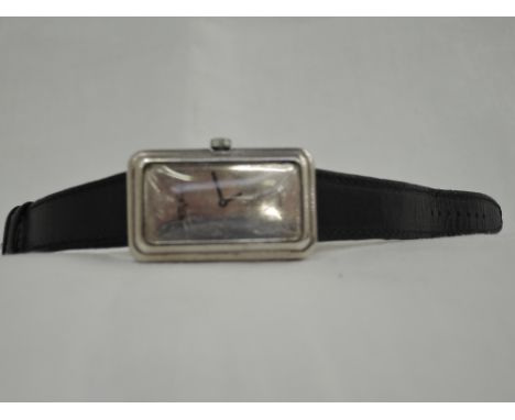 A 1970's silver wrist watch by Roy King having  black pointers to a blank mirrored rectangular face on a black leather strap,