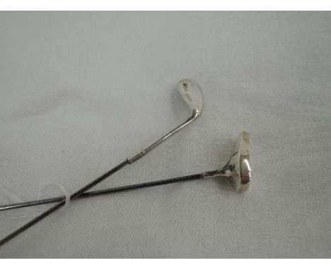 An Edwardian silver hat pin modelled as a golf putter, Birmingham 1906, M Bros, and another modelled as a golf club, Birmingh