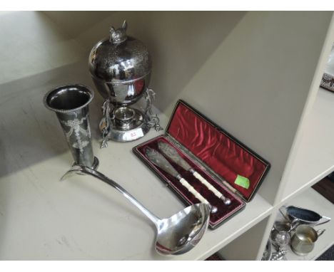 A small selection of plated ware including egg coddler having chicken finial and burner, large soup ladle, pair of cased fish