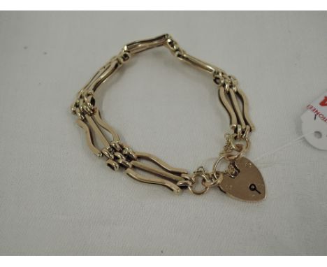A yellow metal 3 bar decorative link gate bracelet stamped 9ct having padlock clasp,  approx 11.5g