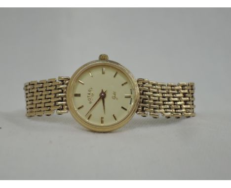 A lady's 9ct gold wrist watch by Rotary having a baton numeral dial to circular face on a five bar 9ct gold gate bracelet str
