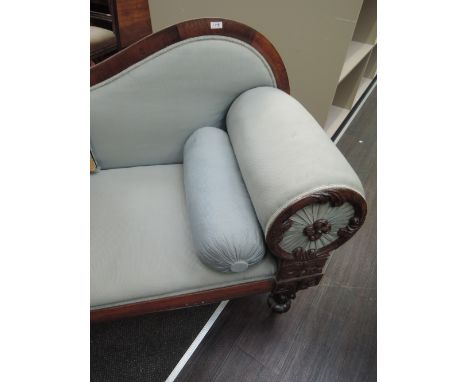 A mid Victorian rosewood frame chaise lounge having sweep back and cushion roll end with foliate applique on petal legs, and 