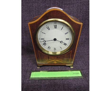 An Edwardian mahogany mantel clock having inlay decoration and circular face, containing Swiss movement