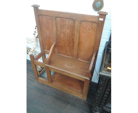 An early 20th century stained mahogany and pine hall seat having panelled back, solid seat and stick stand