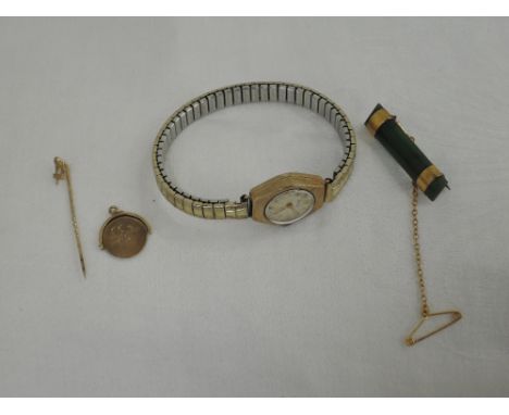 A small selection of 9ct gold and yellow metal jewellery including wrist watch, pendant, jade bar brooch and pin