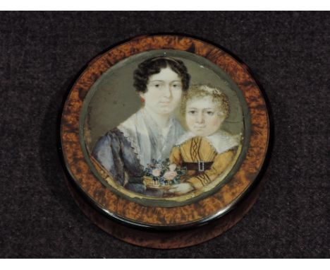 An early 19th century walnut circular trinket box having painted portrait decoration, mother and child, in the style of Vaill