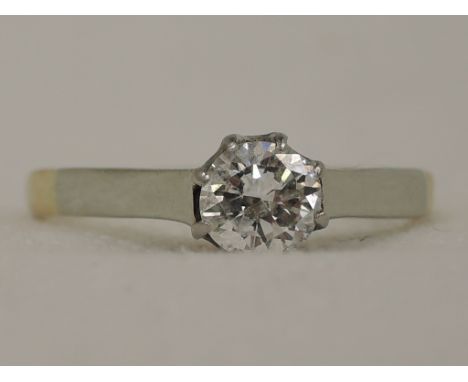 A lady's dress ring having a diamond solitaire, approx .5ct in a claw mount to raised shoulders on a yellow metal loop stampe