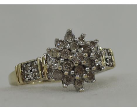 A lady's dress ring having a diamond triple cluster, approx .5ct to diamond set banded shoulders on a 9ct gold loop,  size M 