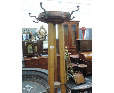 An early 20th century stained frame office hat/coat stand having tapered frame and splay legs 
