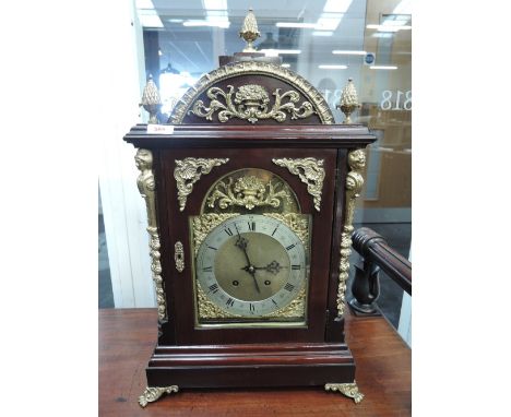An early 20th century bracket clock in the 18th century style having mahogany case and gilt metal applique and pineapple fini