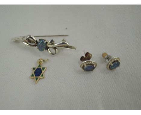 A white metal bar brooch stamped 925 having a central opal in a decporative bow, a pair of opal stud earrings in white metal 