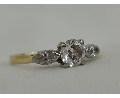 A lady's dress ring having a diamond solitaire, approx .5ct having marquise cut diamonds to shoulders on an 18ct gold loop, s