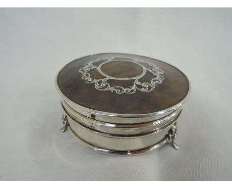 An Edwardian silver and tortoise shell trinket box of circular form having silver picque decoration to lid, silk interior and