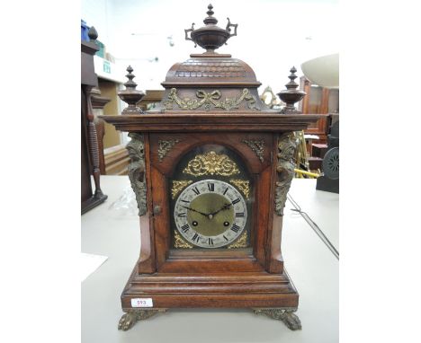 A late 19th century mahogany case German bracket clock, with brass mounts and applique with striking movement chiming on the 