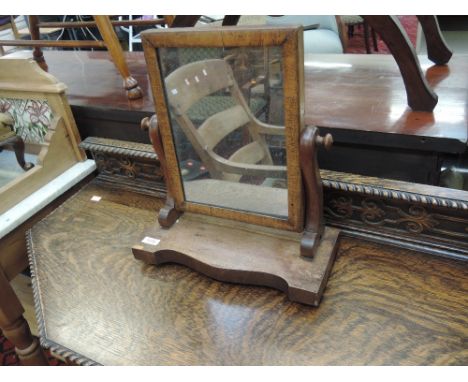 A Victorian mahogany toilet mirror having rectangular top and scroll supports