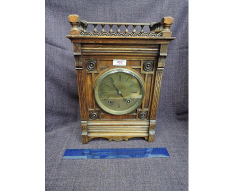 An Edwardian mahogany cased mantel clock having spindle top with circular brass dial and striking movement