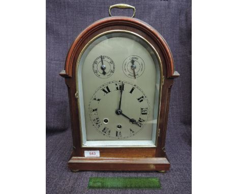 An Edwardian mahogany mantel clock having arch silvered Roman numeral dial with subsidiary dials and striking movement