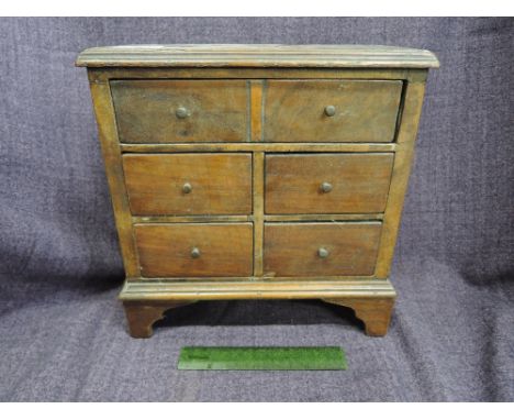 A 19th century mahogany miniature specimen chest of six short drawers on bracket feet 