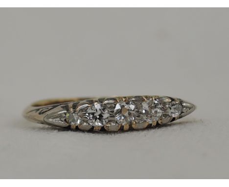 A lady's dress ring having five graduated diamonds in a gallery mount on a yellow metal loop stamped 18ct,  size L/M