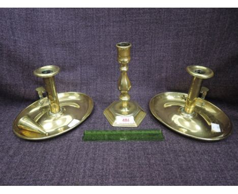 A pair of 19th century brass candlestands of Wee Willy Winkie design and a 19th century brass candlestick of Queen Anne style