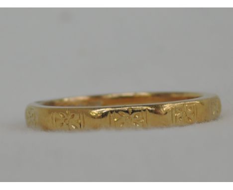 A 22ct gold wedding band having shaped and moulded decoration, approx 3.3g & size K