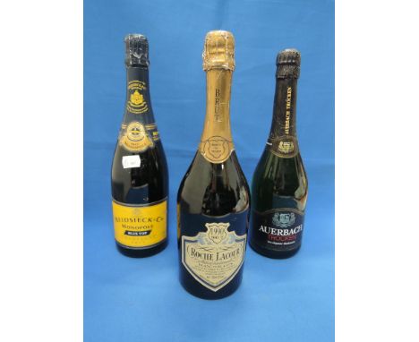 Three bottles of sparkling wine, Roche Lacour 1990 Brut, Heidsieck & Co, Monople Blue Top Champagne, Auerbach Troken