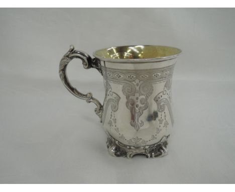 A Victorian silver tankard/mug having brightcut decoration with monogram to cartouche,gilt interior, moulded bracket foot and