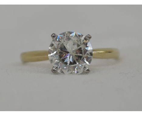 A lady's dress ring having a moissanite solitaire, approx 1.75ct in a raised four claw mount on an 18ct gold loop,  size M