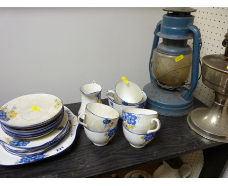 Twenty one piece Staffs blue and yellow teaset, hurricane lamp and an aluminium oil lamp