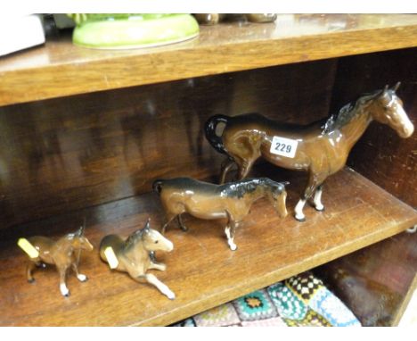 Beswick/Doulton pottery stallion, small mare and two ponies