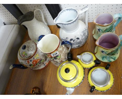 Three piece yellow and black pottery tea service, two Majolica type jugs, a pewter lidded jug etc