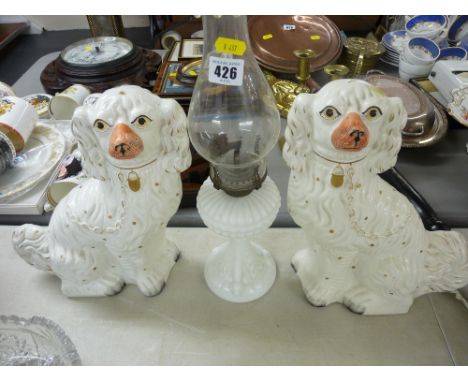 Vintage glass oil lamp and a pair of white Staffs comforter dogs