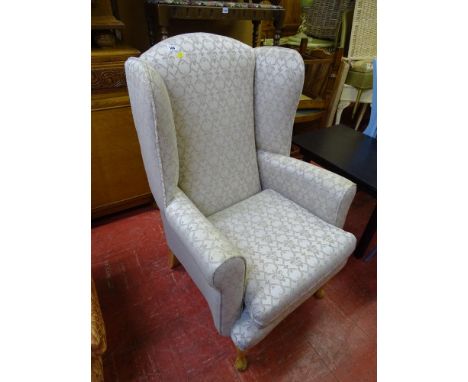 Light patterned classically upholstered wingback chair