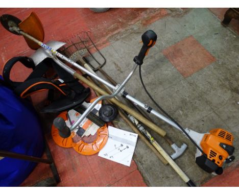 Stihl trimmer and accessories and a small parcel of long handled garden tools