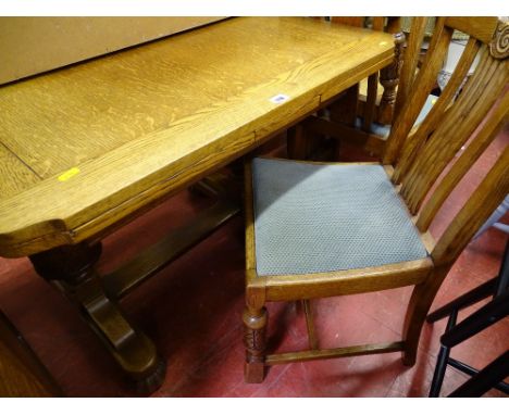 Light oak draw leaf table and four upholstered chairs