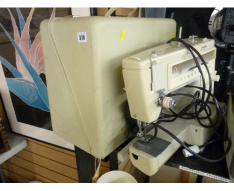 Vintage electric Singer sewing machine in case with foot pedal