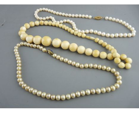 Ivory graduated bead necklace, a freshwater pearl necklace with oval nine carat gold clasp having three inset pearls and anot