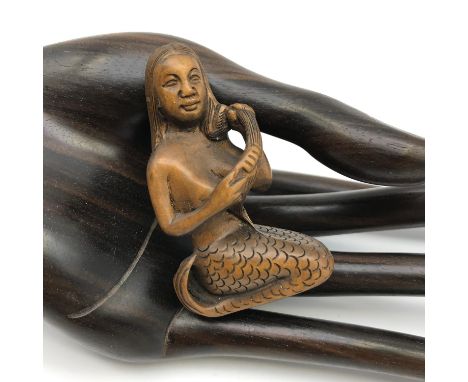 A Japanese hand carved netsuke figure of a Mermaid brushing her hair. Signed by the Artist. 
