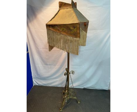 A Victorian brass rise and fall paraffin lamp converted to an electric standard light. Comes with a hide style shade. 