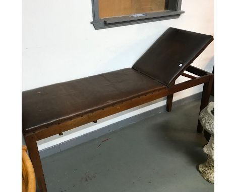 A Vintage examination bed, with rise and fall head rest. Also has a pull out writing slope. 