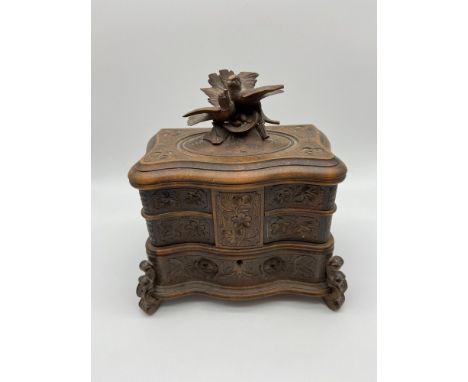 A Beautifully made 19th century Black Forest jewel box. Detailed with hand carvings of flowers and foliage. Topped with two h