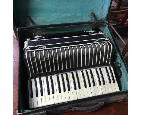 A Vintage Italian Pietro Deluxe full size piano accordion with travel case. 